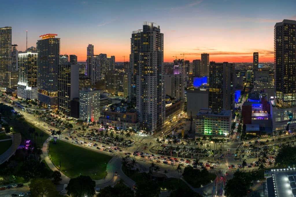 Brightly illuminated skyscraper buildings and traffic in downtown district of Miami Brickell